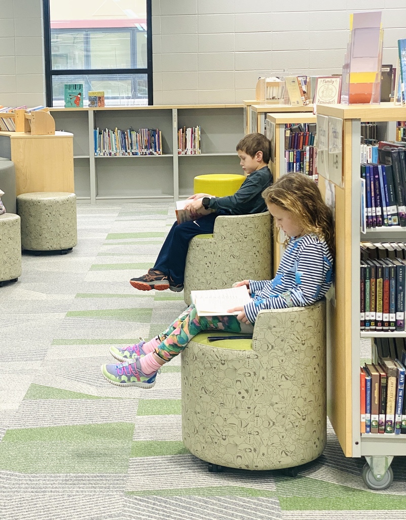 two students reading in the library